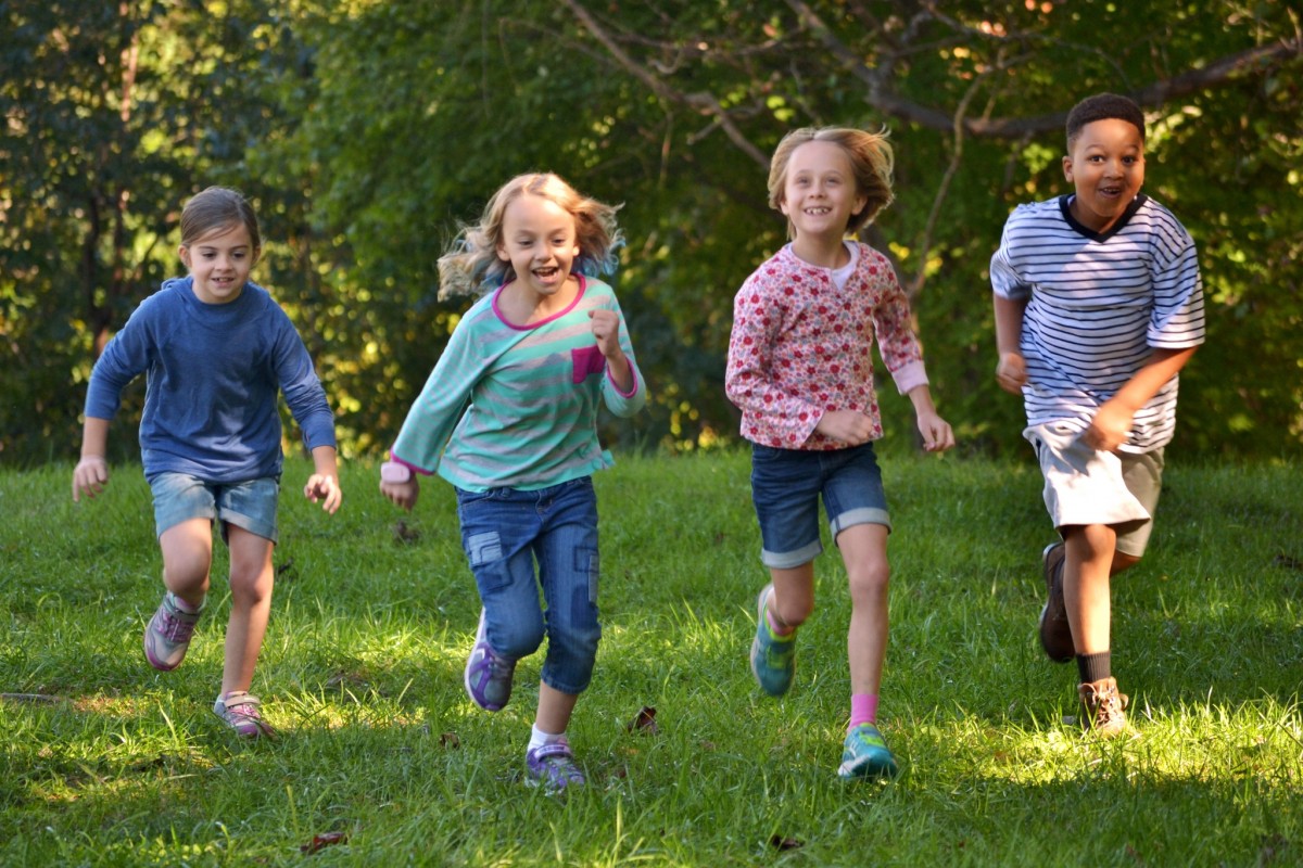 Children running in the woods