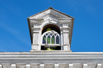 A worker removes a window at Flat Top Manor for restoration. 